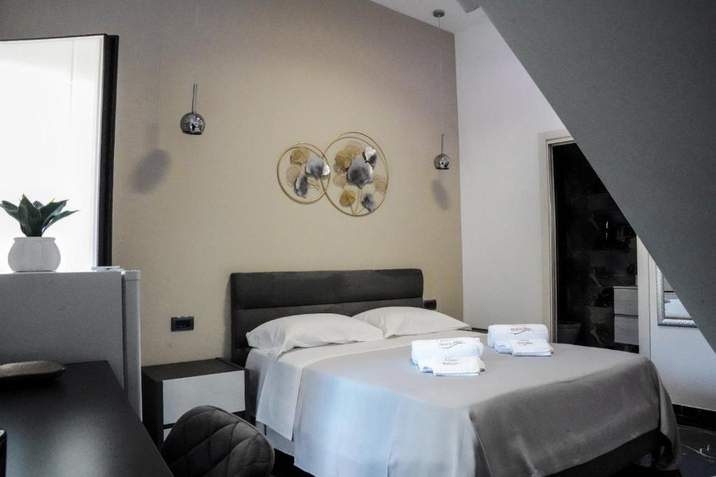 a bedroom with a bed with two towels on it at Francy's bed & bliss in Somma Vesuviana