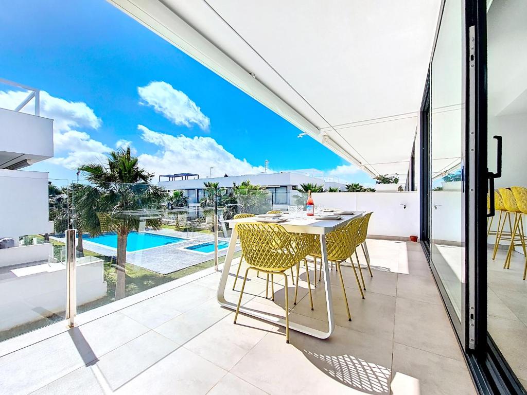 a balcony with a table and chairs and a view of a pool at Antilia Terraces Colibri Apartment - 5710 in Mar de Cristal