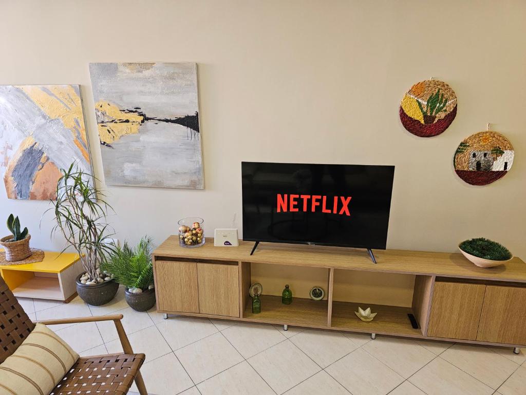 een televisie bovenop een houten entertainmentcentrum bij Tirana Center Apartment 12 in Tirana