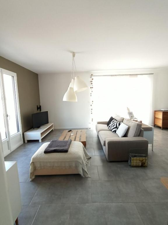 a living room with a couch and a bed at Maison au calme à la campagne PERIGNY HOUSE in Périgny-la-Rose