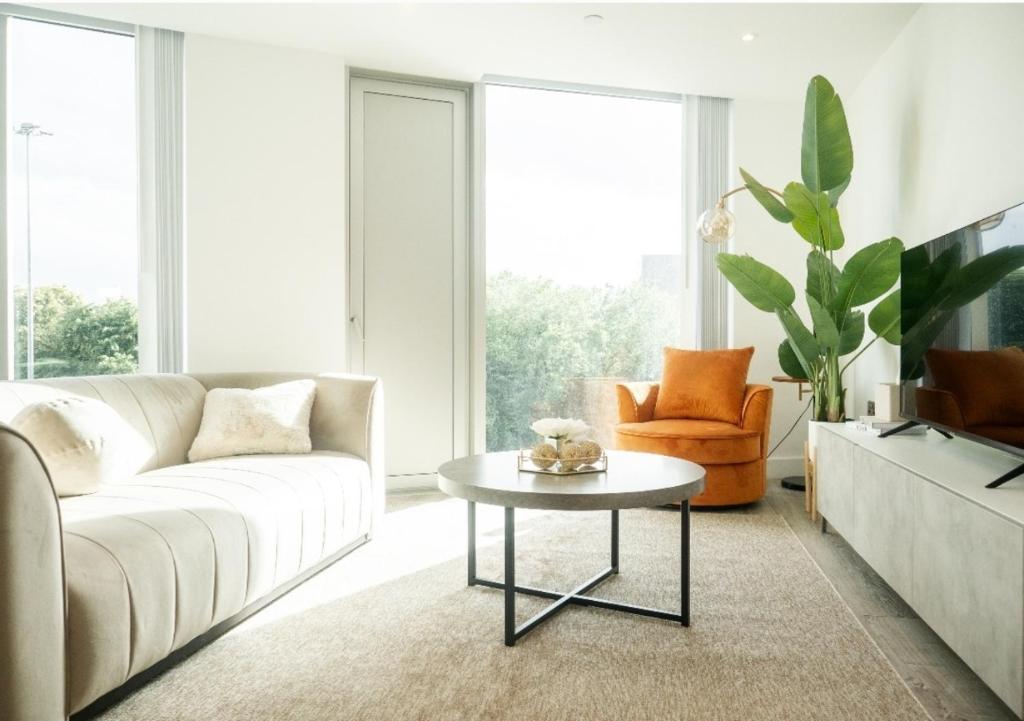 a living room with a white couch and a table at Central Manchester Skyline in Manchester