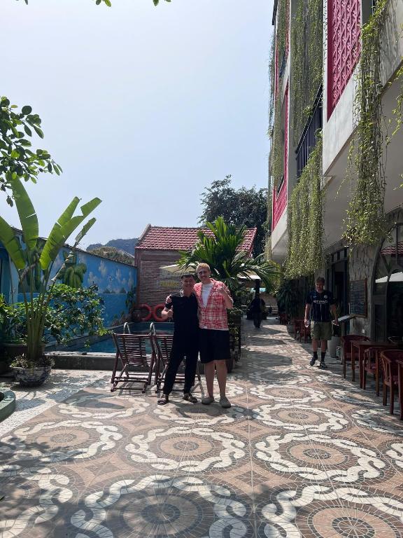 a group of people standing on a tiled sidewalk at Tam Coc Paradise Homestay in Ninh Binh