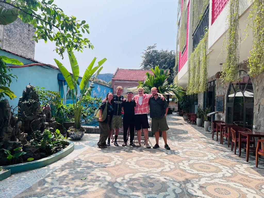 a group of people posing for a picture on a street at Tam Coc Paradise Homestay in Ninh Binh
