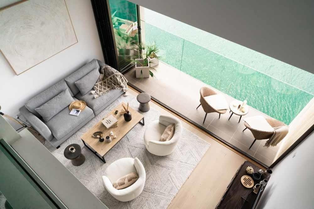 a view of a living room with a couch and chairs at 3 Bedroom Luxury Waterside House in Hayle
