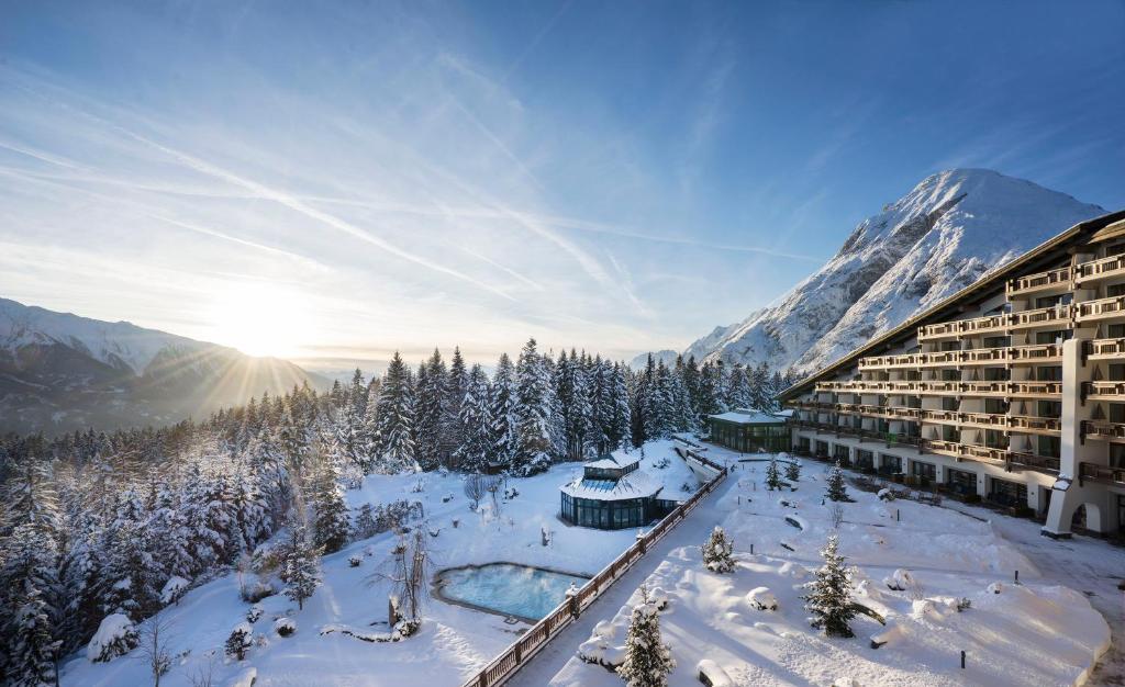 a hotel in the mountains with snow on the ground at Interalpen-Hotel Tyrol in Buchen