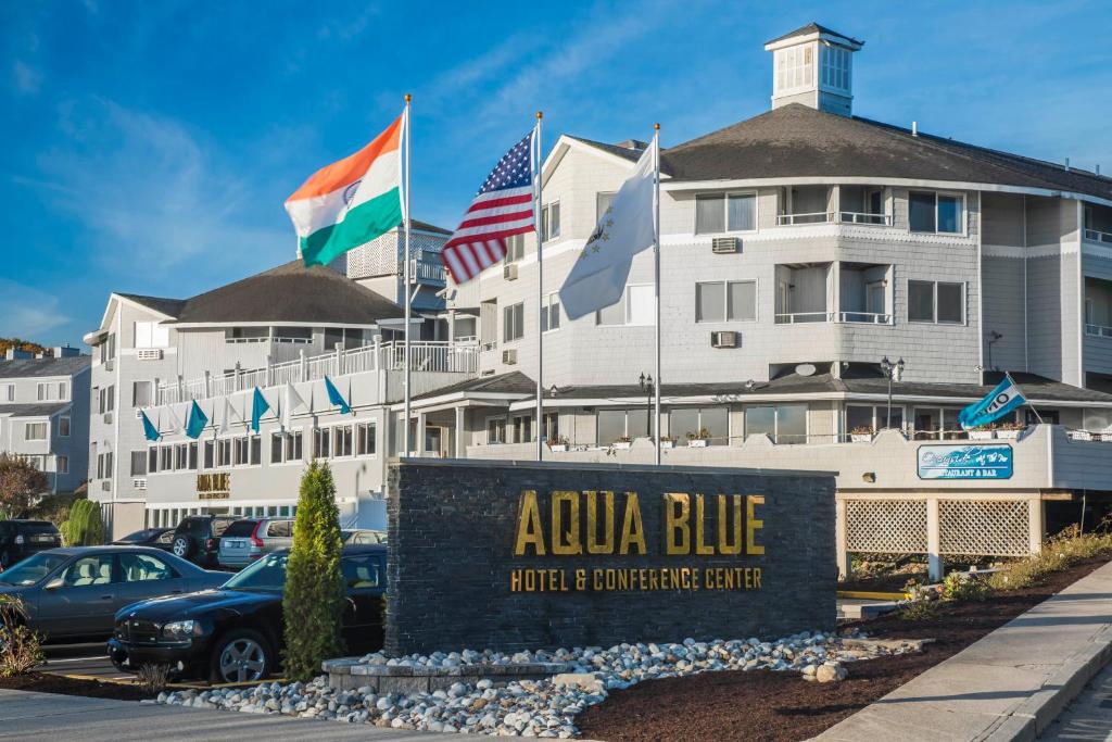 a building with flags and a sign in front of it at Aqua Blue Hotel in Narragansett