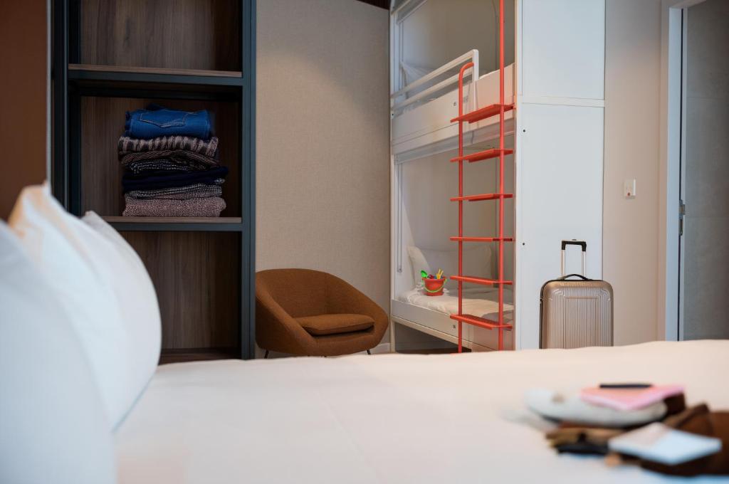 a bedroom with a bed and a walk in closet at YOU Are Deauville in Deauville