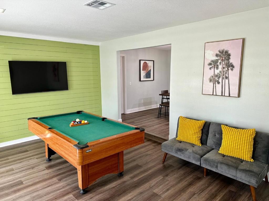 a living room with a pool table and a couch at Orlando Luxe Retreat with Private Pool in Orlando