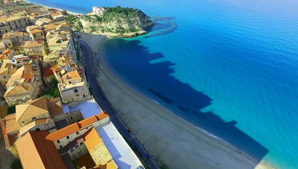 an aerial view of a beach with houses and the ocean at Palazzo Tranfo Al Duomo Accommodation in Tropea