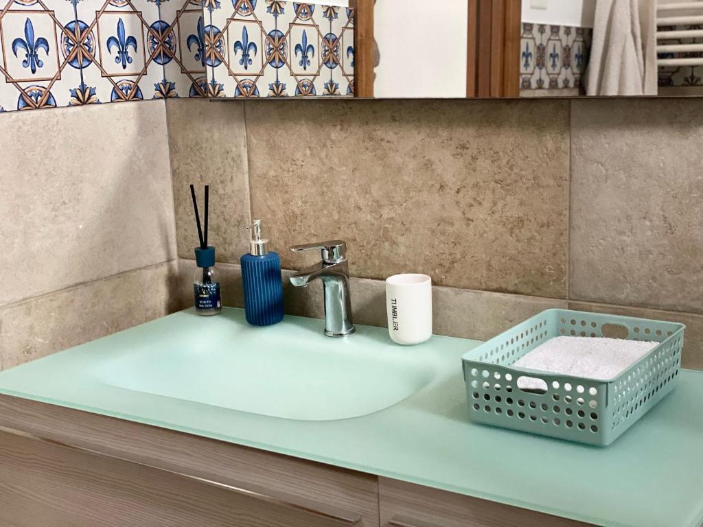 a bathroom sink with a basket on the counter at Casa Francesco in Forza dʼAgro
