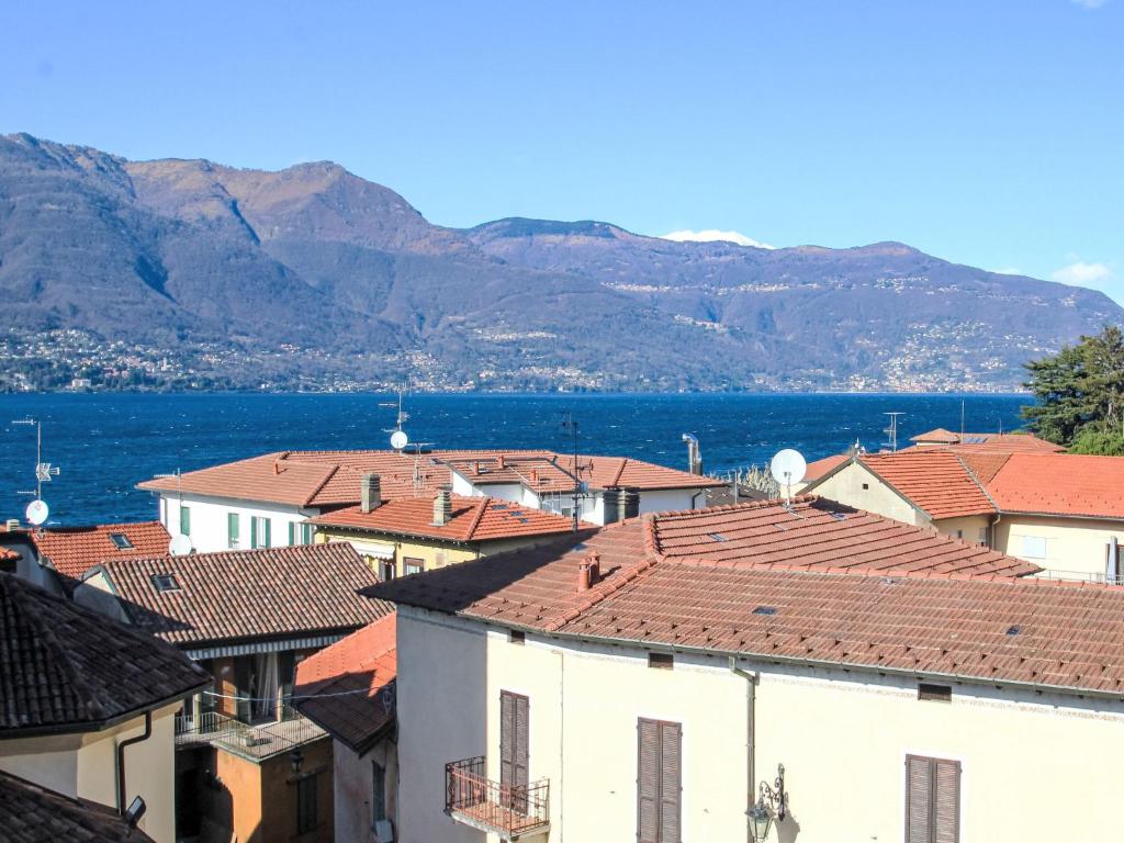 a group of buildings with mountains in the background at Apartment Roma by Interhome in Porto Valtravaglia