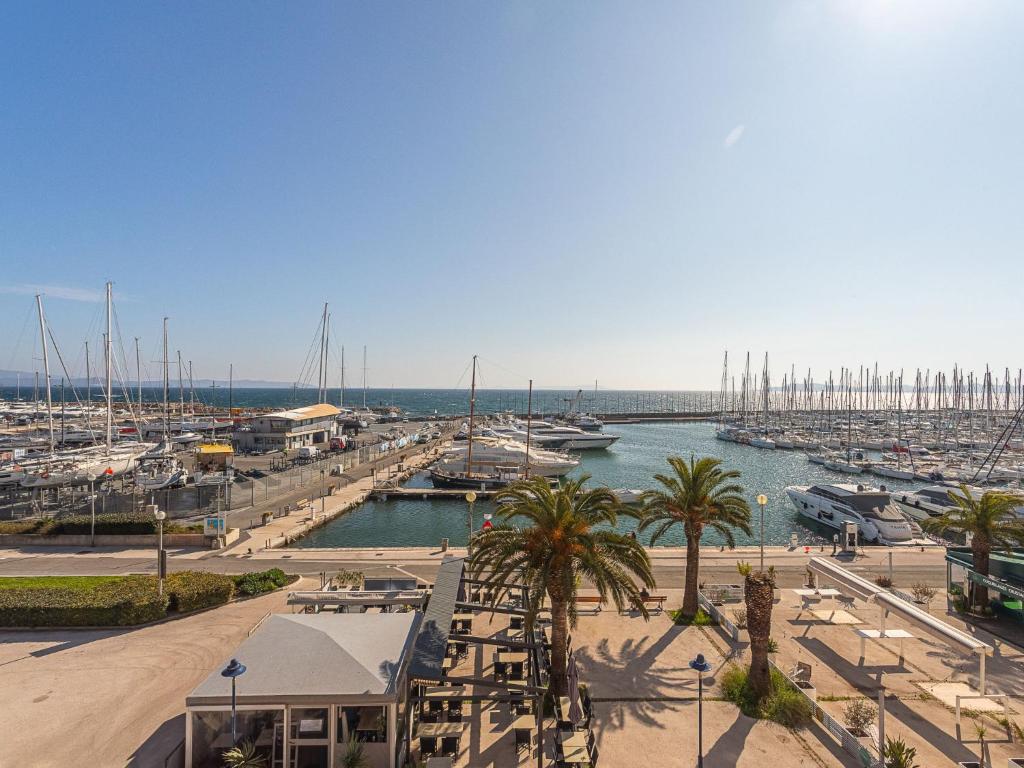a marina with a bunch of boats in a harbor at Apartment La Balancine by Interhome in Hyères