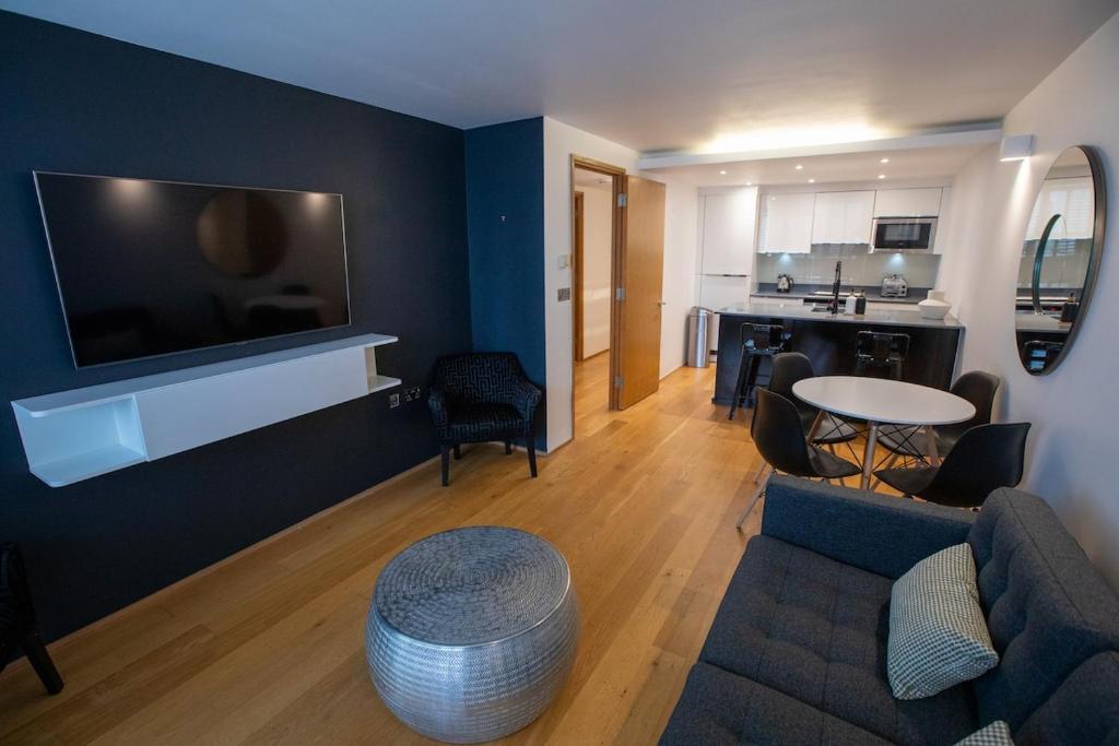 a living room with a couch and a table at Luxury London Apartment in London