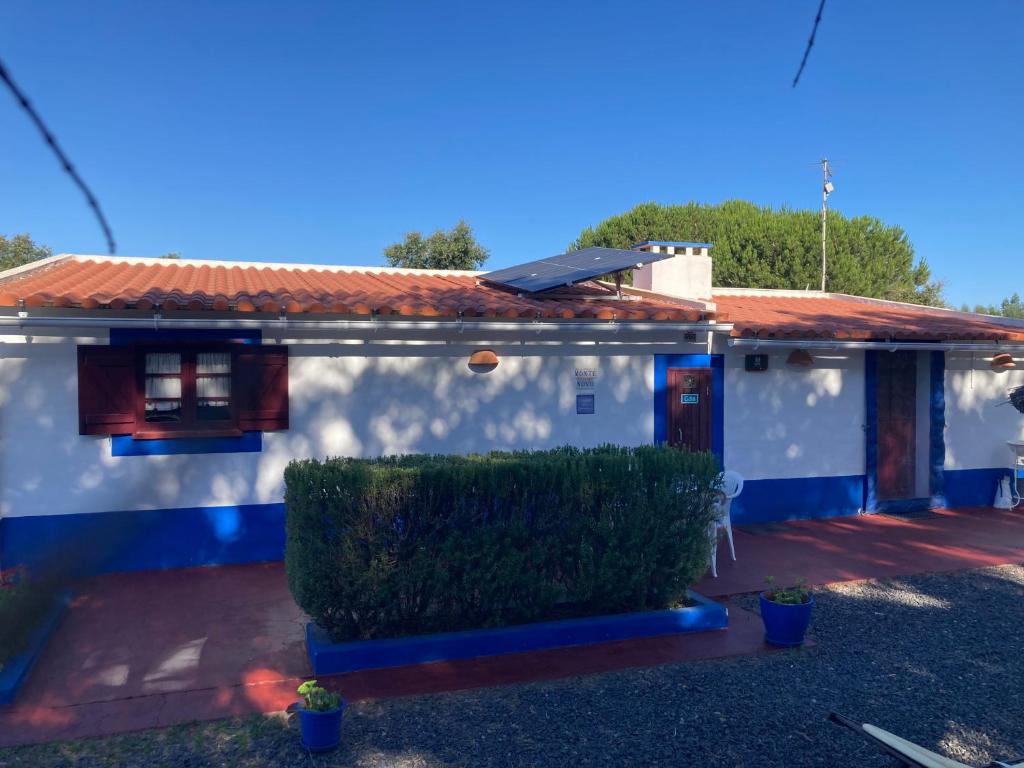 a white and blue house with a red roof at Ninho das Perdizes - Monte Novo in Cercal