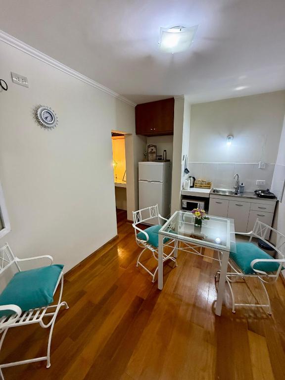 a living room with a table and chairs and a kitchen at Shanti Loft in San Juan