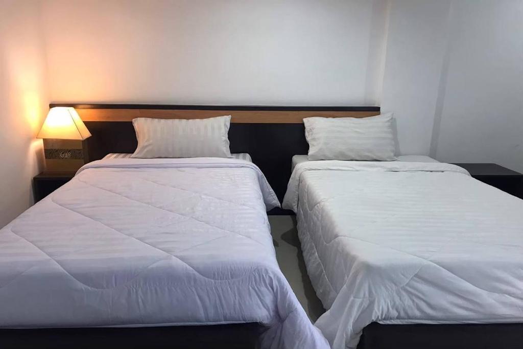 Postel nebo postele na pokoji v ubytování Praew Mansion