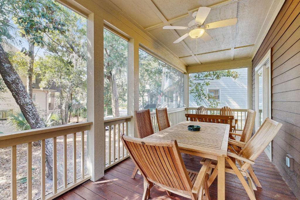 a dining room with a table and chairs on a porch at Ocean Green 26 in Kiawah Island