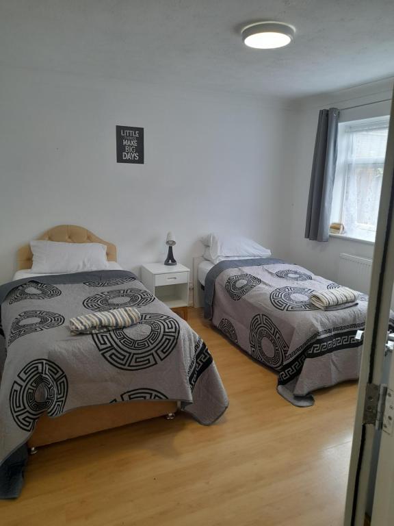 a bedroom with two beds and a window at Bridgewoods in Chatham