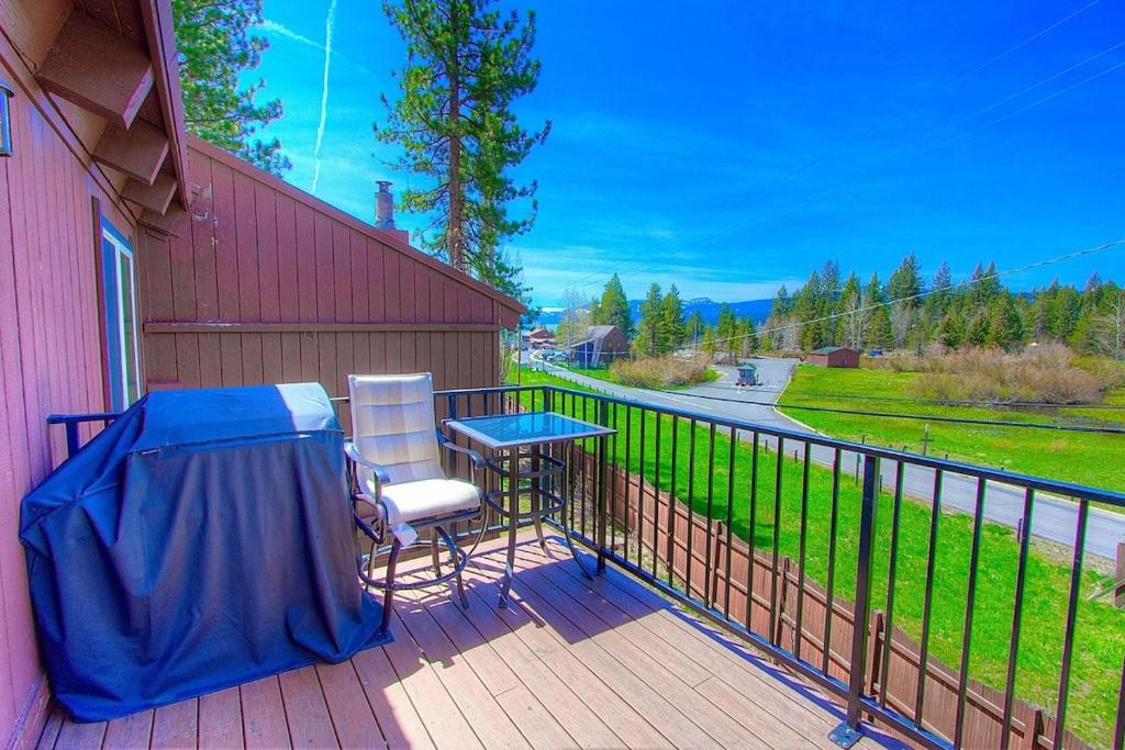 a balcony with a table and chairs on a fence at Park View Paradise condo in Tahoe City