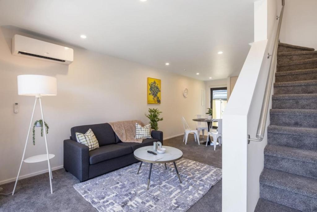 a living room with a couch and a table at Ariki Shire A Wellington Fantasy in Lower Hutt
