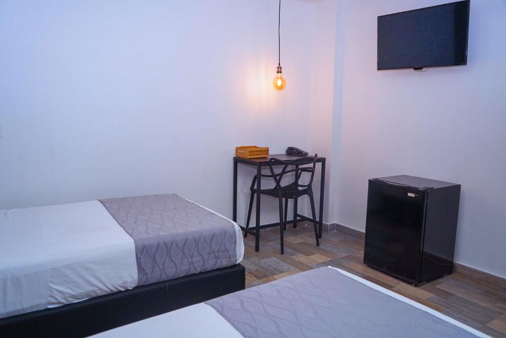Postel nebo postele na pokoji v ubytování Hotel Palmas del Estadio