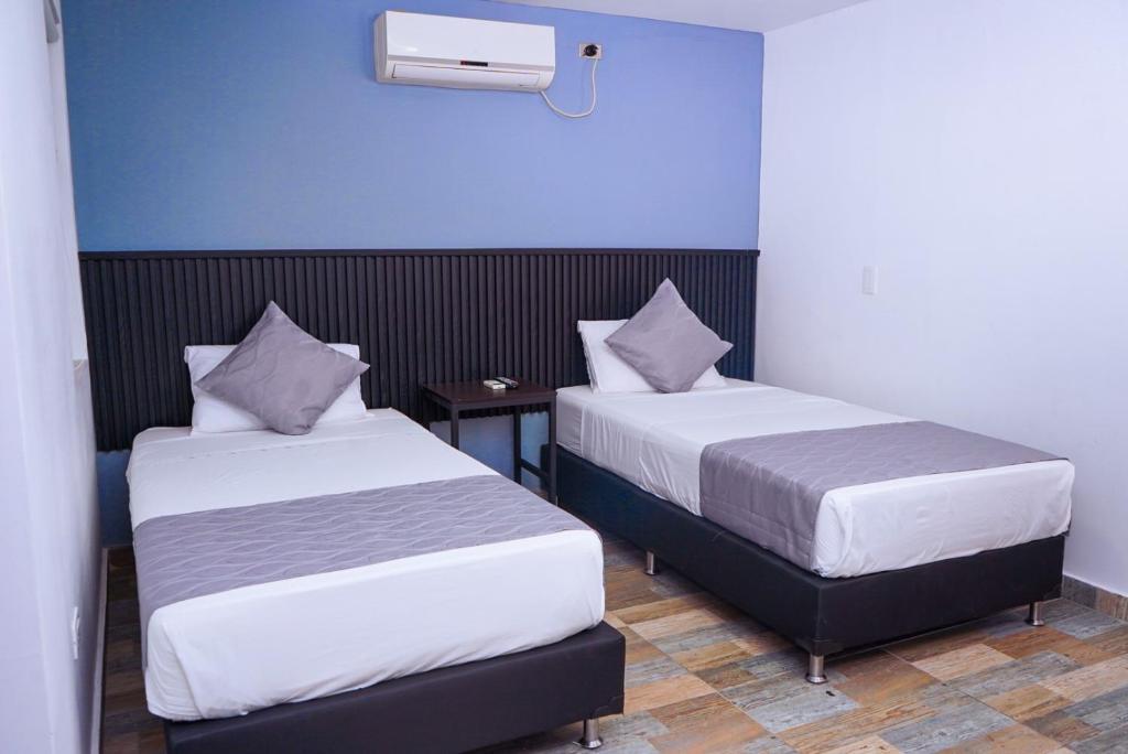 Postel nebo postele na pokoji v ubytování Hotel Palmas del Estadio