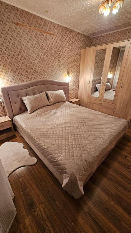 a bedroom with a large bed in a room at Celtnieku 14 in Ventspils