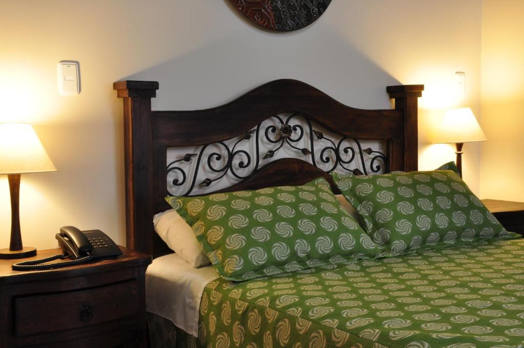 Postel nebo postele na pokoji v ubytování Hoteles Bogotá Inn La Soledad