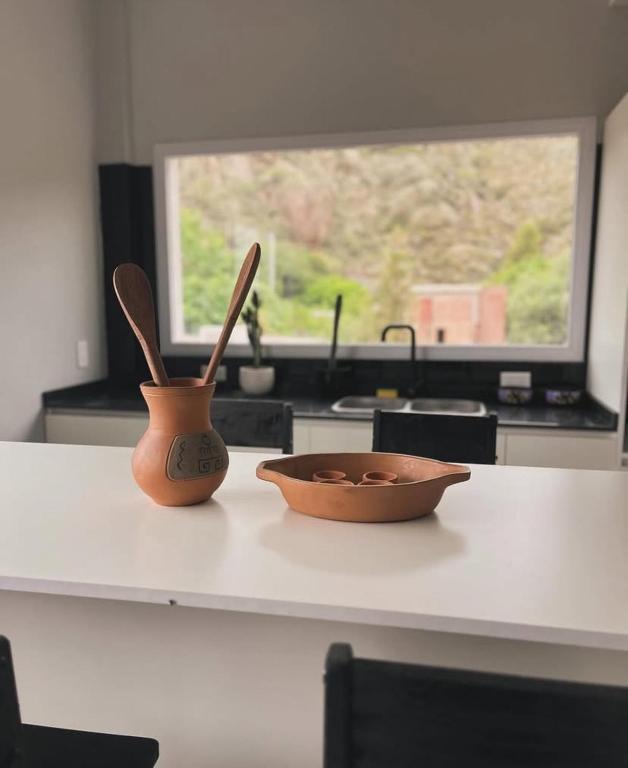 two wooden utensils sitting on a counter in a kitchen at Inti Belén in Belén