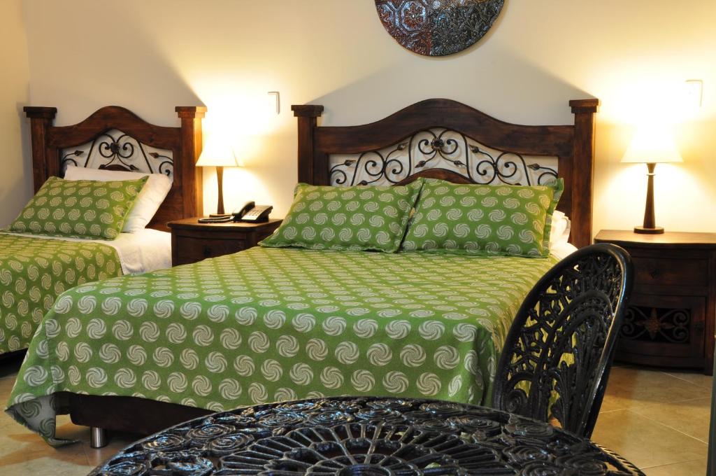 Postel nebo postele na pokoji v ubytování Hoteles Bogotá Inn La Soledad