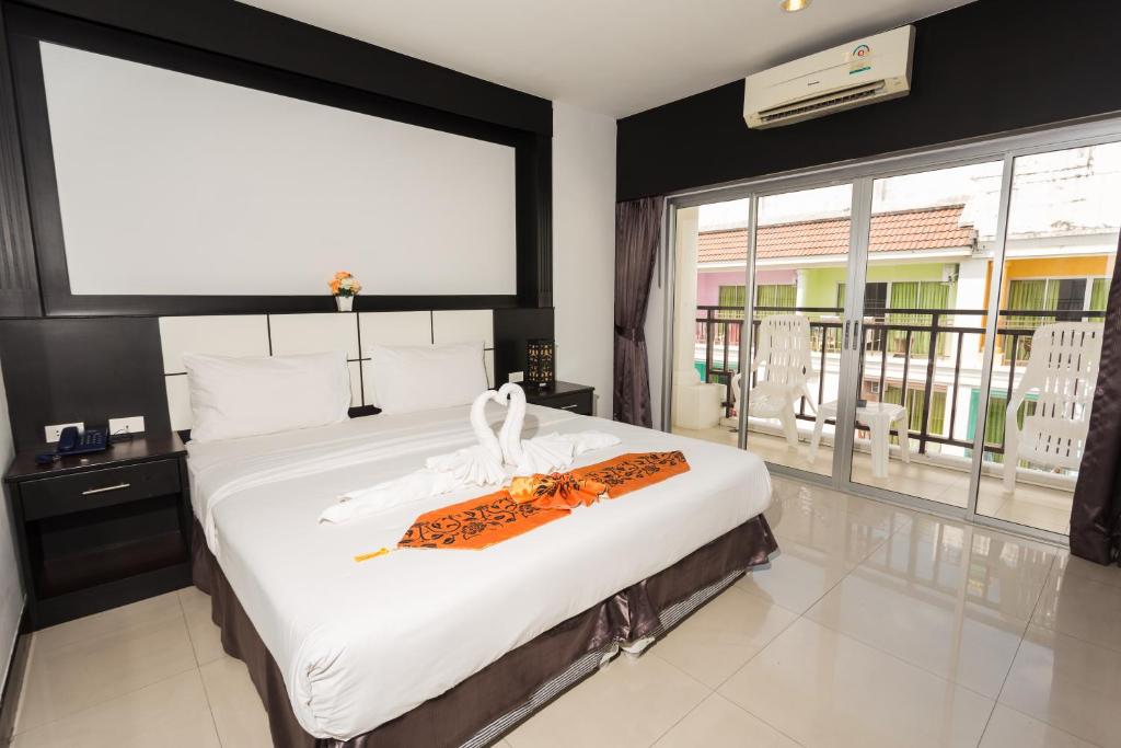 Postel nebo postele na pokoji v ubytování Star House Patong
