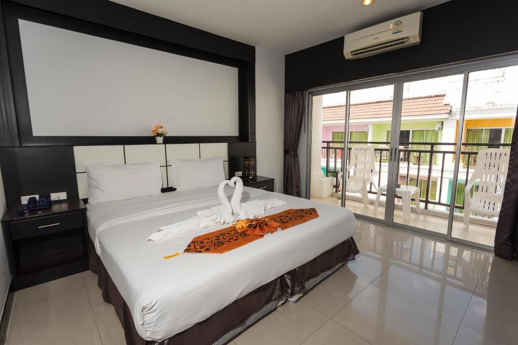 Postel nebo postele na pokoji v ubytování Star House Patong