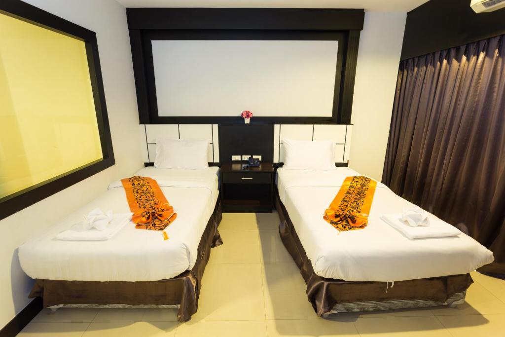 Postel nebo postele na pokoji v ubytování Star House Patong