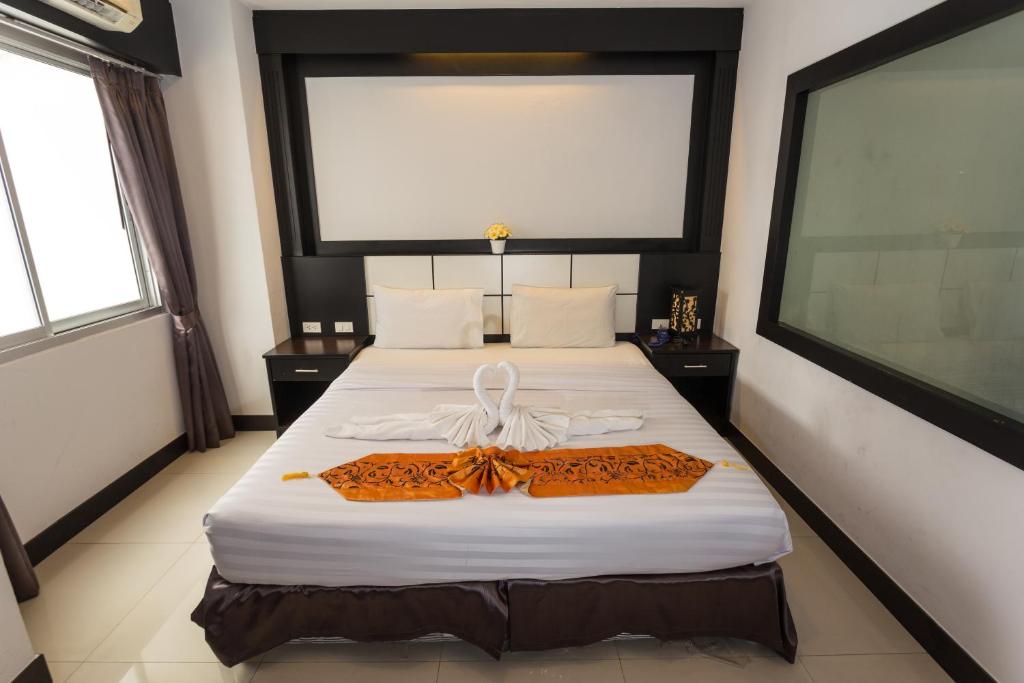 Postel nebo postele na pokoji v ubytování Star House Patong