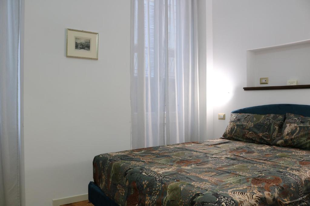 Postel nebo postele na pokoji v ubytování Casa Elli Serbelloni 12