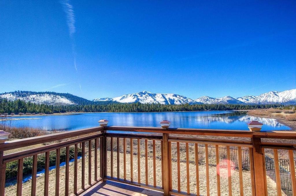 a balcony with a view of a lake and mountains at Epiphany home in South Lake Tahoe