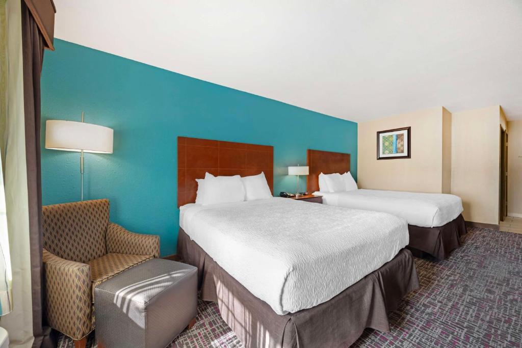 a hotel room with two beds and a chair at Best Western Central City in Central City