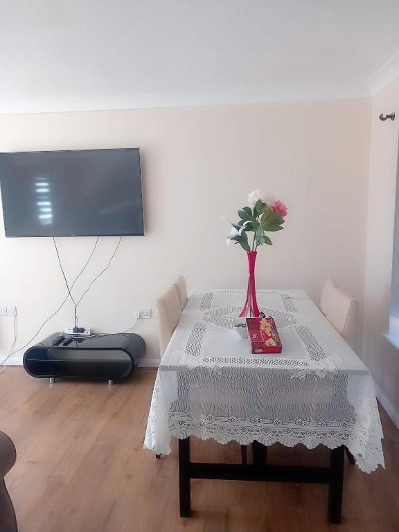 a table with a vase of flowers on top of it at 2 bedroom apartment in Erith
