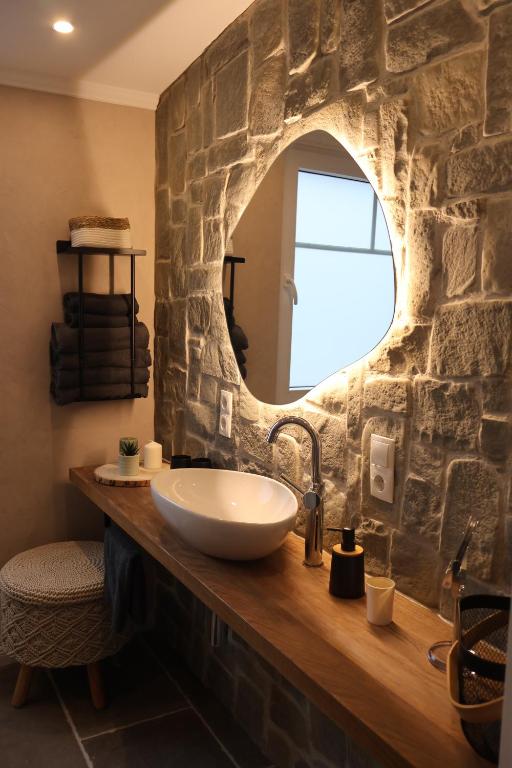 a bathroom with a sink and a stone wall at Ferienhaus AhrIdylle in Bad Neuenahr-Ahrweiler