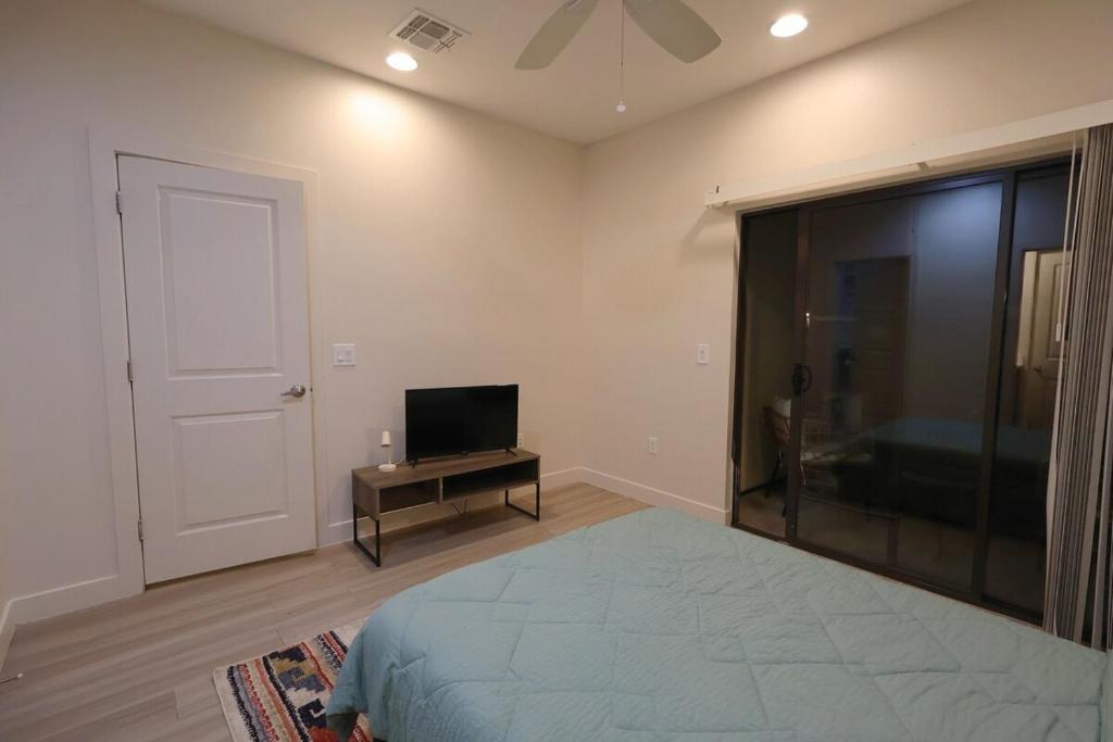 a bedroom with a bed and a flat screen tv at Central To Phoenix and Scottsdale Spacious 3BR Escape in Phoenix! in Phoenix