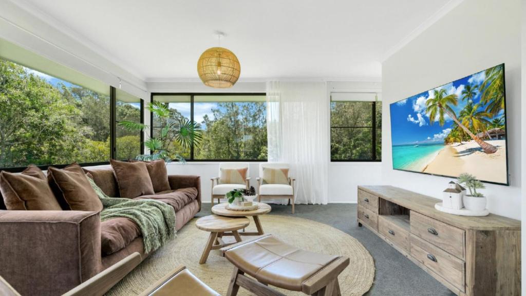 a living room with a couch and large windows at Peking Duck - Sleeps 7, Luxe Riverside Retreat in Repton
