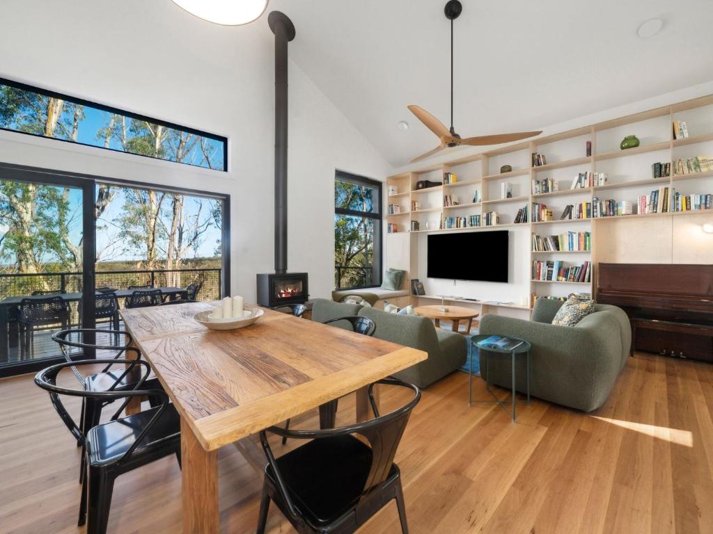 a living room with a dining table and a tv at Birdsong Blackheath in Blackheath