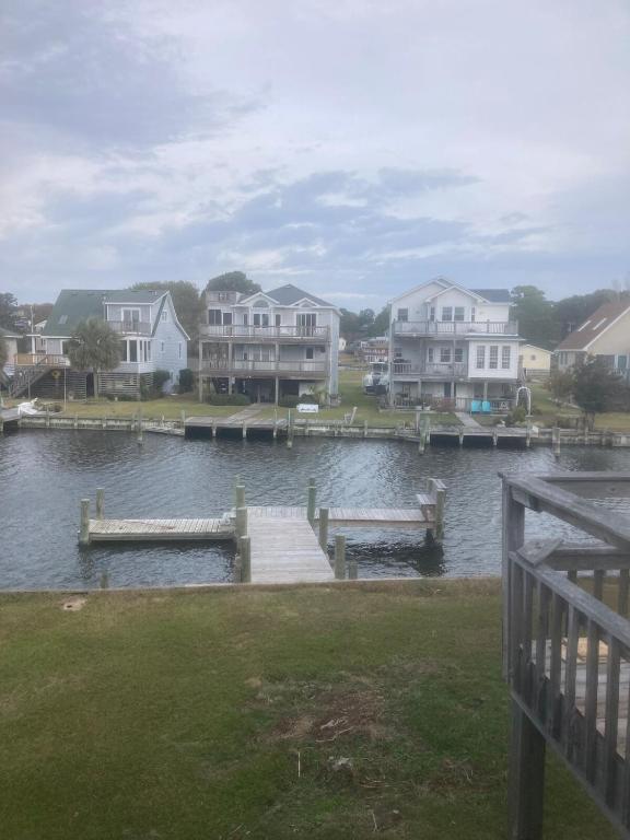 a view of a lake with houses and a dock at Canal Front Boater's Paradise in Kill Devil Hills