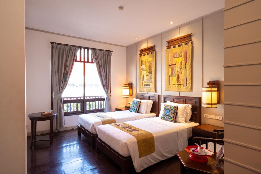 Ένα ή περισσότερα κρεβάτια σε δωμάτιο στο Pukha Nanfa Hotel