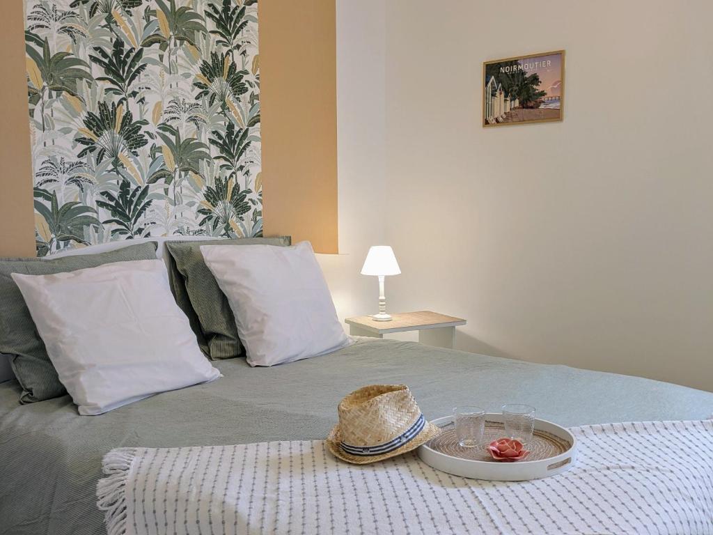 - un lit avec un chapeau et une plaque dans l'établissement Charmant gîte Coquelicot près des plages vendéennes - FR-1-426-573, à Saint-Gervais