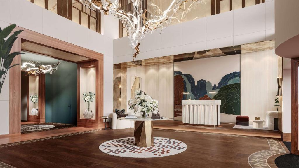 a lobby with a table with flowers on it at Conrad Hamburg in Hamburg