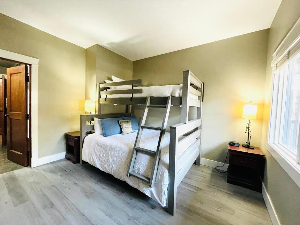 a bedroom with a bunk bed with a ladder at Solara Getaway 2BR Condo with Pool - Hot Tub - Gym - Spa in Canmore