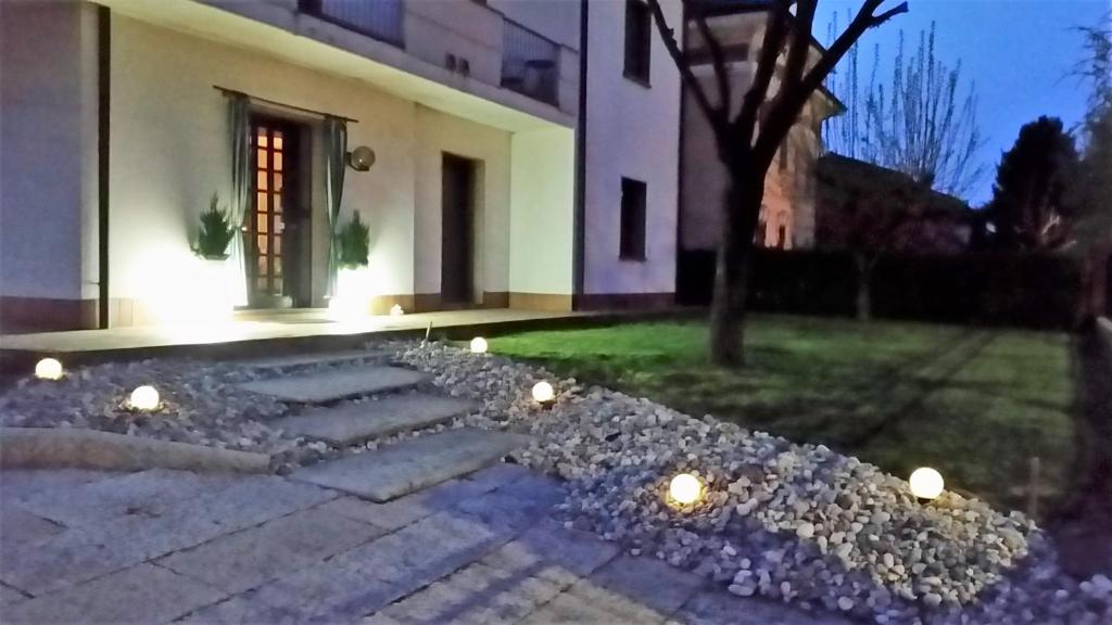 a house with lights in the yard at night at B&B Casa Silingardi in Bagnolo San Vito