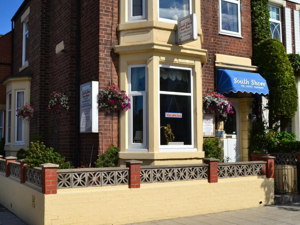 a brick building with a window on a street at South Shore Guest House in South Shields