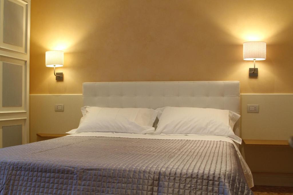 Posteľ alebo postele v izbe v ubytovaní B&B I Propilei di San Girolamo